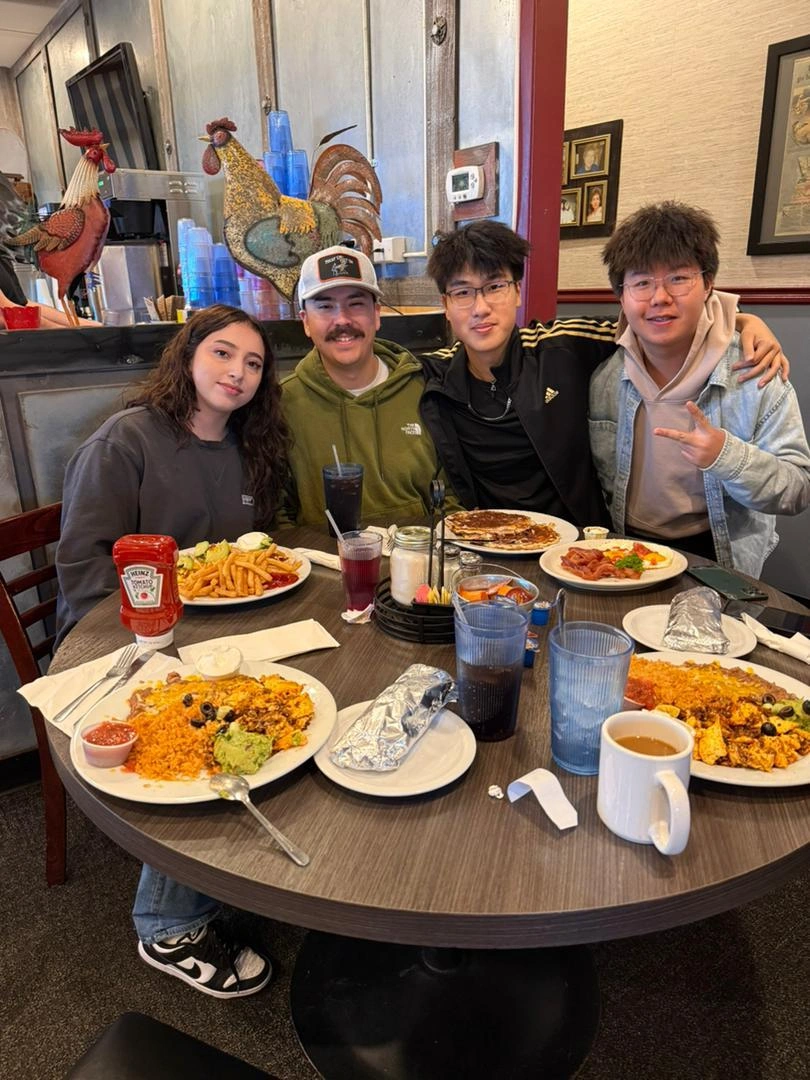 Host family sharing a meal with international students during an ERDT enVision cultural exchange homestay